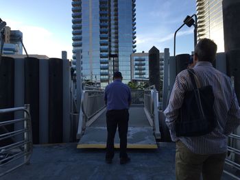 Men standing by footbridge at williamsburg