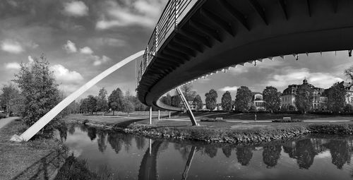 Arch bridge over river against sky