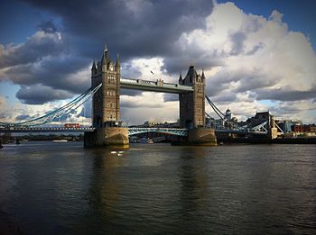 Bridge over river against cloudy sky