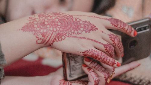 Cropped hand of woman wearing wedding dress