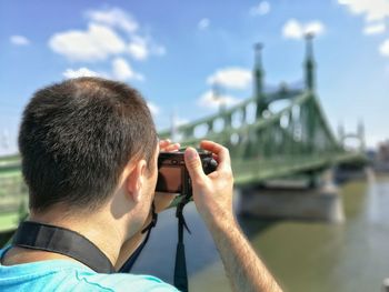 Rear view of man photographing