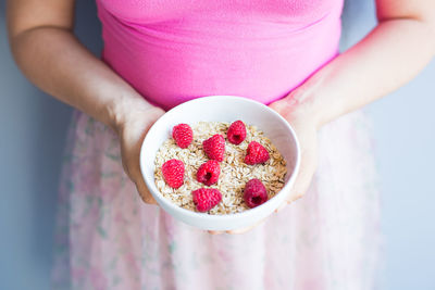 Midsection of woman holding apple