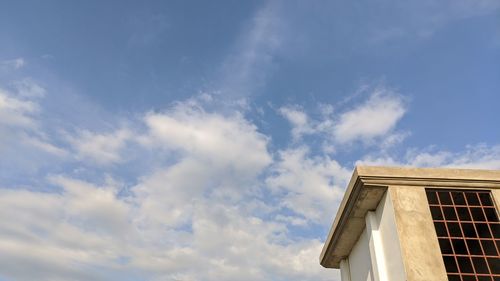 Low angle view of building against cloudy sky