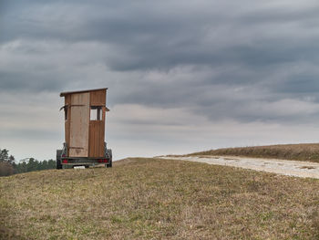 Built structure on field against sky