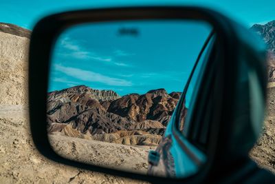 Reflection of sky on side-view mirror