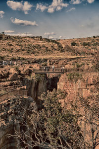 View of rock formations on landscape against sky