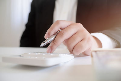 Close-up of woman hand on table