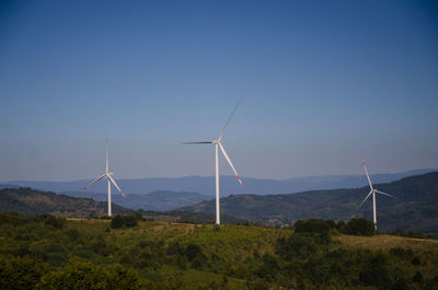 Windmill on field against sky