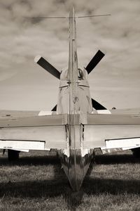 Airplane on field against sky