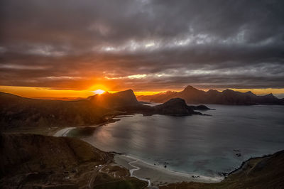 Scenic view of beaches and mountains against sky during sunset