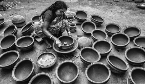 High angle view of woman making clay pots at village