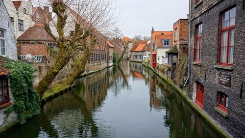 Reflection of houses on water in city