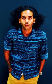 Portrait of mid adult man against blue background