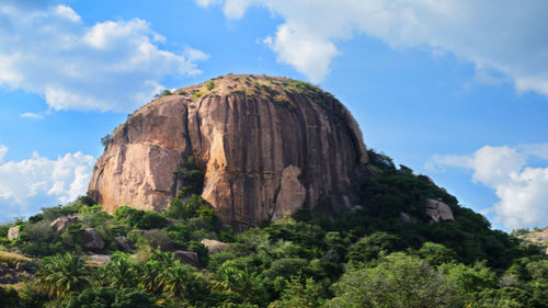 Low angle view of rock formations against sky