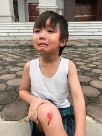 Portrait of boy crying outdoors