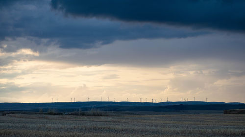 Scenic view of field against sky during sunset