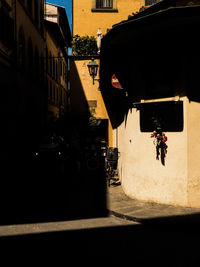 Silhouette people on street amidst buildings