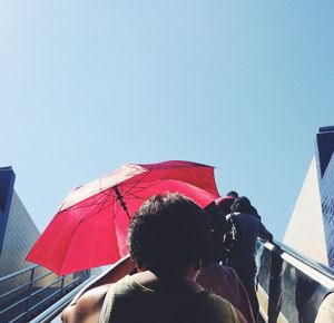 Low angle view of woman against clear sky