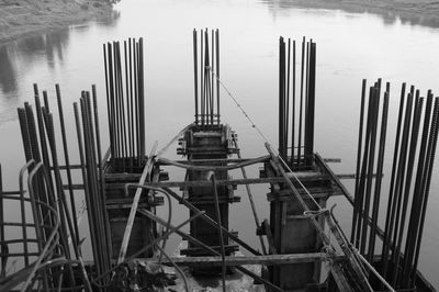 High angle view of wooden post by sea against building