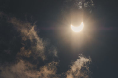 Low angle view of bright sun in sky