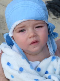 Portrait of cute baby girl wearing hat