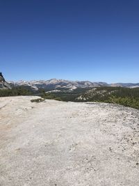 Scenic view of mountains against clear blue sky