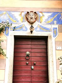 Low angle view of sculpture on wall of house