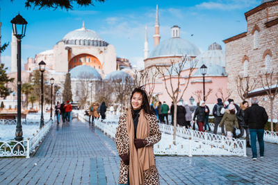 Rear view of woman standing in city