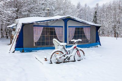 Caravan with tent on a snowy winter day
