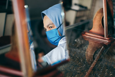 Woman looking away while wearing face mask during pandemic