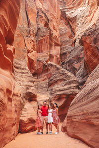 Rear view of people walking on rock formations