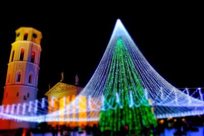 Low angle view of illuminated christmas tree at night