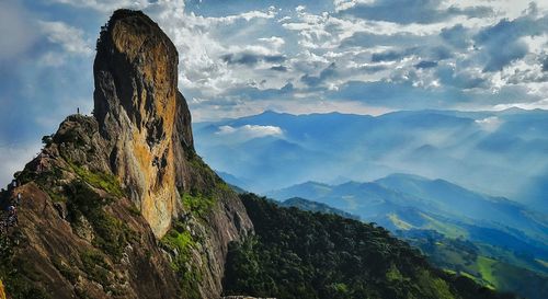 Scenic view of mountains against cloudy sky