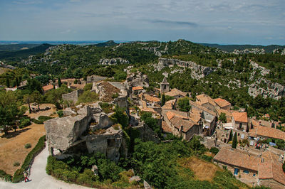 View of the baux-de-provence castle ruins on the hill, with roofs of the village just below, france.