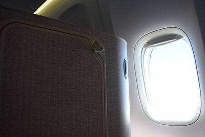 Close-up of airplane against sky seen through window