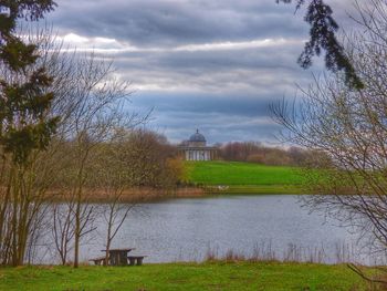 Scenic view of lake against cloudy sky