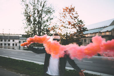 Close-up of man with smoke bomb