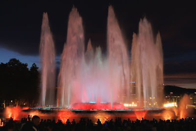 Fountain against sky at night