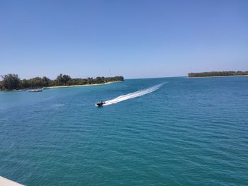 Scenic view of sea against clear blue sky