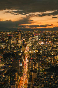 High angle view of illuminated city buildings at night