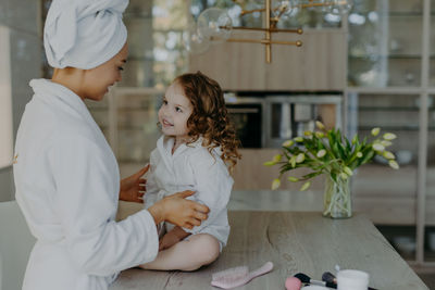 Smiling mother with daughter at home