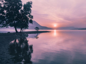 Scenic view of lake against sky during sunset