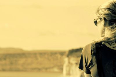 Close-up of woman standing against sky