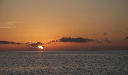 Scenic view of sea against romantic sky at sunset