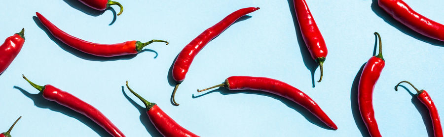 Close-up of red chili peppers against yellow background