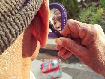 Close-up of man shaving beard