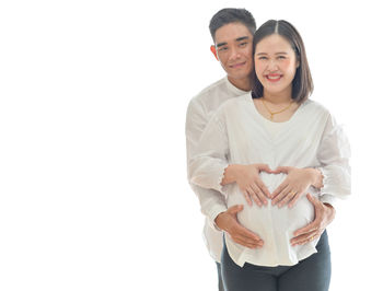 Happy couple against white background