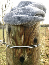 Close-up of wooden post on field during winter