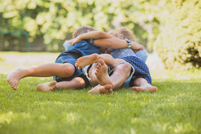 Rear view of father and son on grass