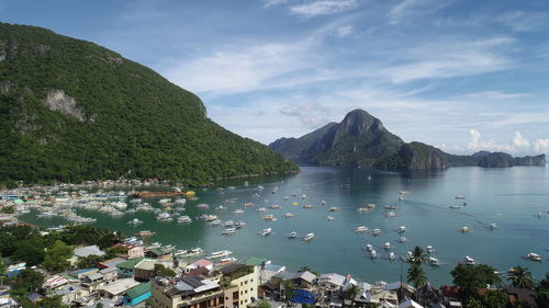 High angle view of bay and mountains against sky